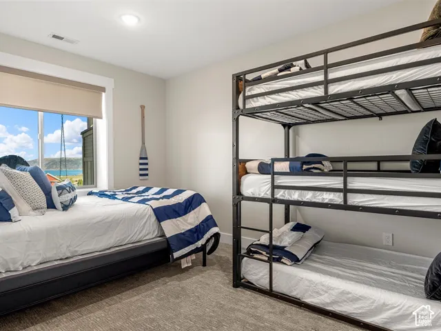 Large window with roller shade, recessed lighting, and light-colored wall paint