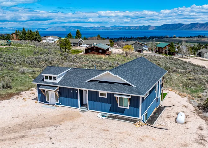 View of front of home featuring a shingled roof, a mountain view, a porch, and board and batten siding