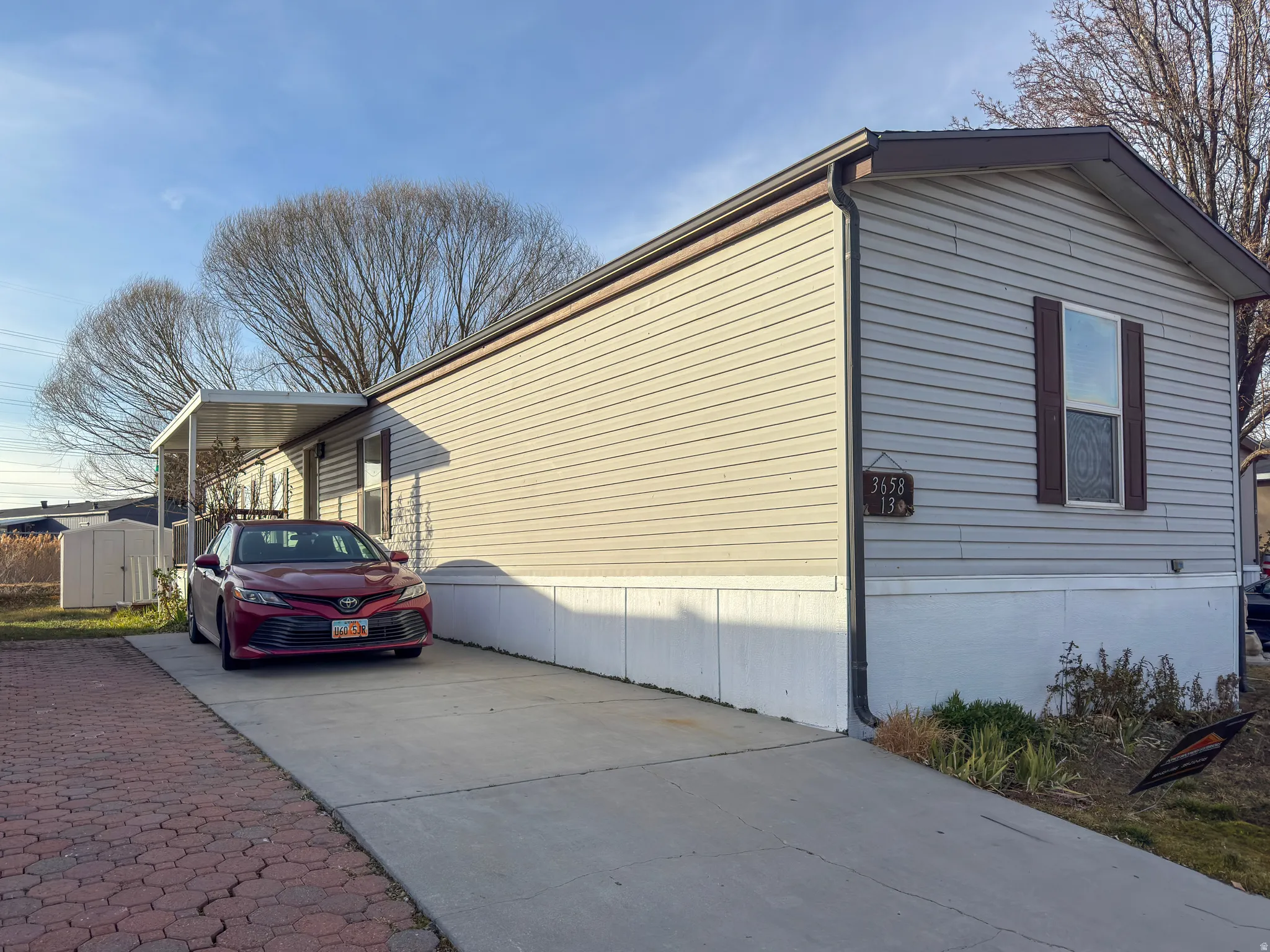 View of home's exterior featuring concrete driveway