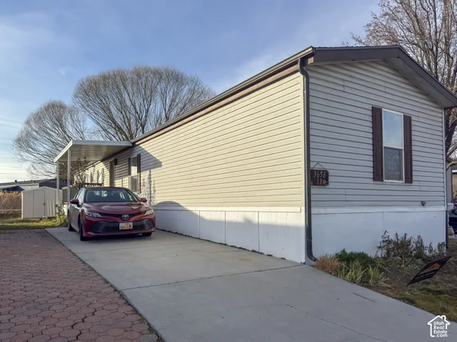 View of home's exterior featuring concrete driveway