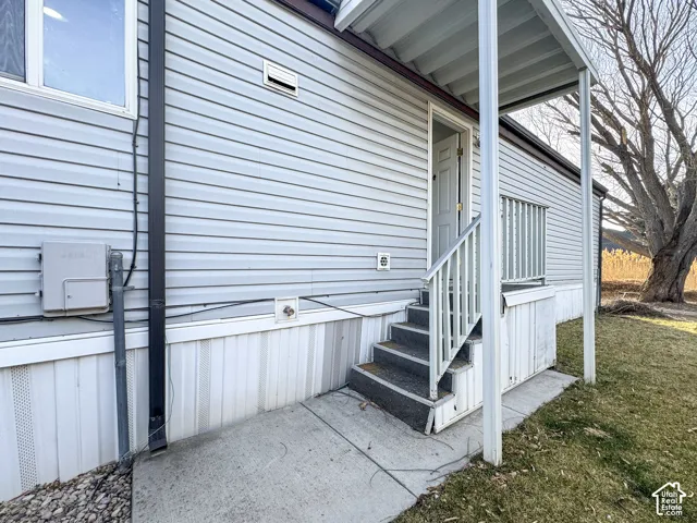 Doorway to property featuring a yard