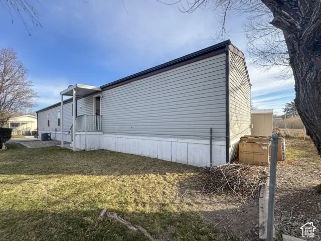View of side of property with a yard