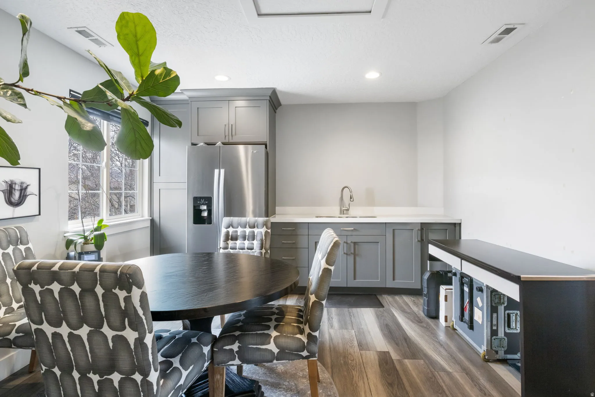 Dining room featuring dark wood-type flooring, recessed lighting, and a textured ceiling