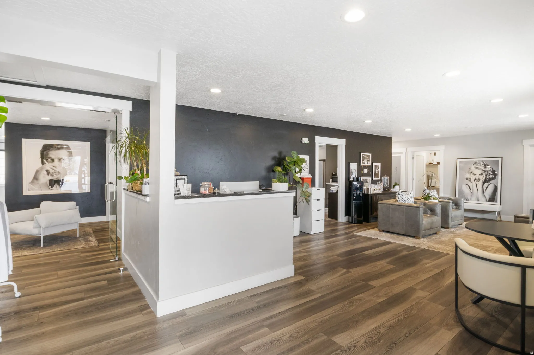 Living room featuring dark wood-type flooring, recessed lighting, and a textured ceiling