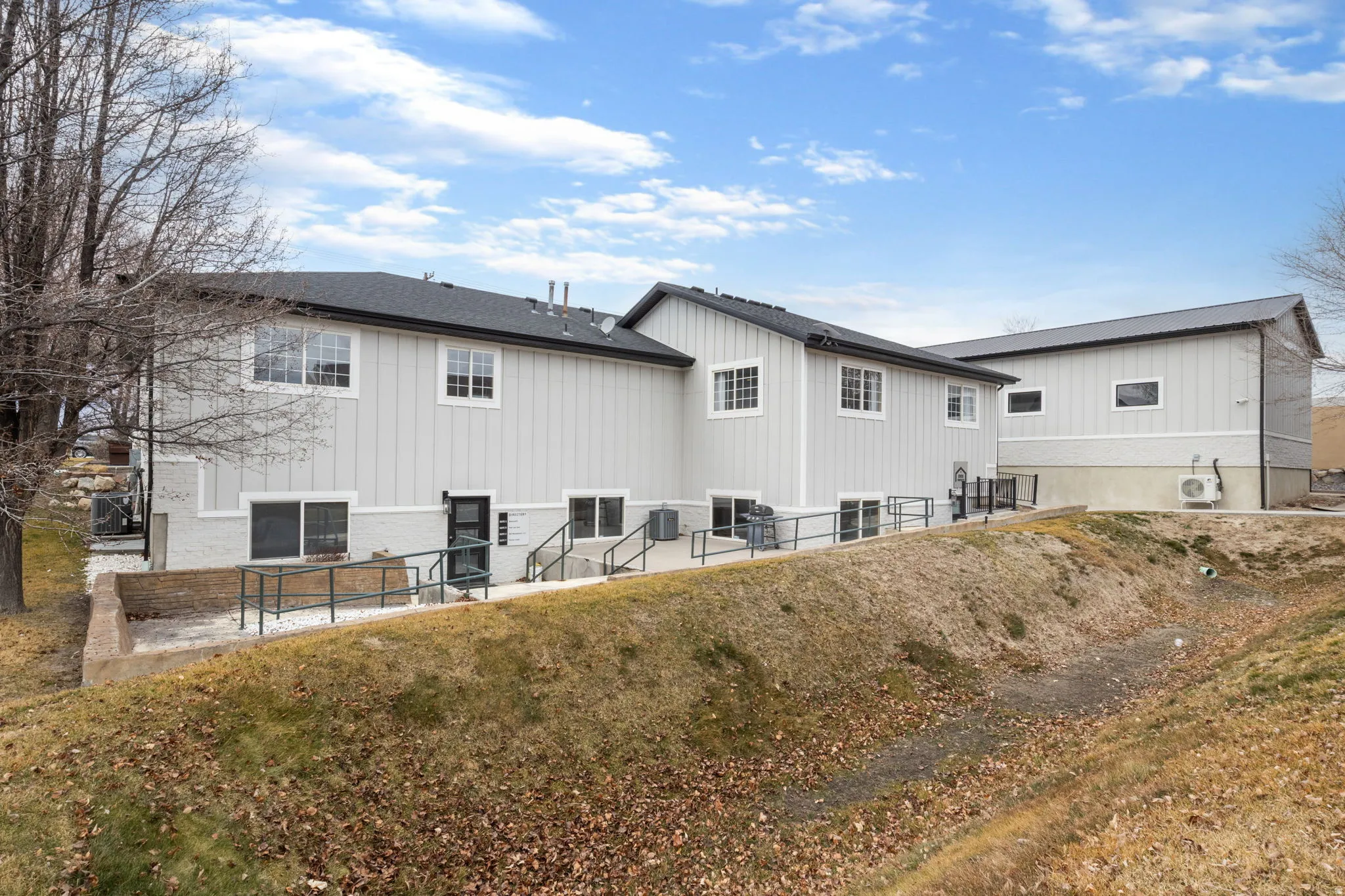 Rear view of house with a patio area and brick siding