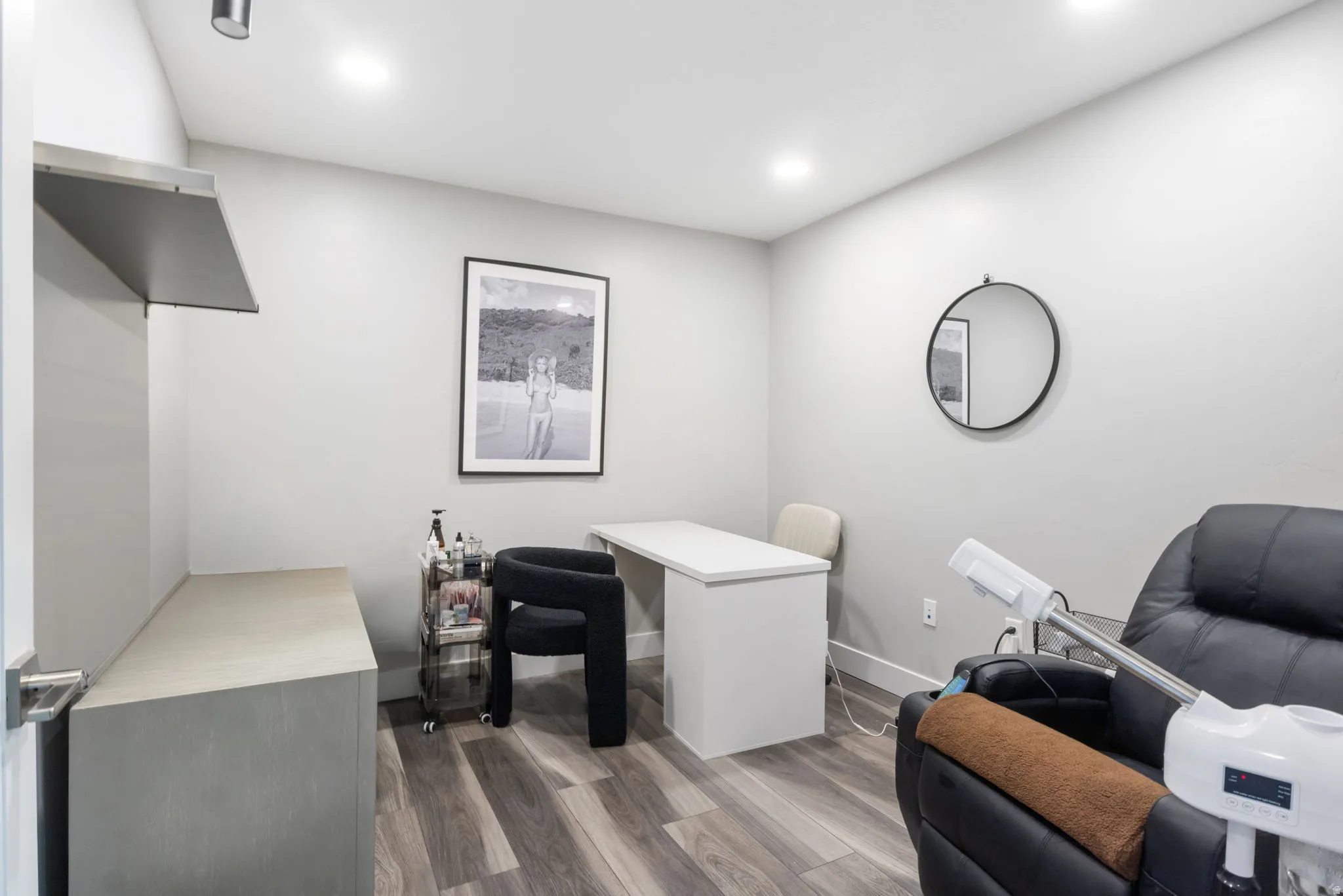 Office space featuring dark wood-style floors and recessed lighting