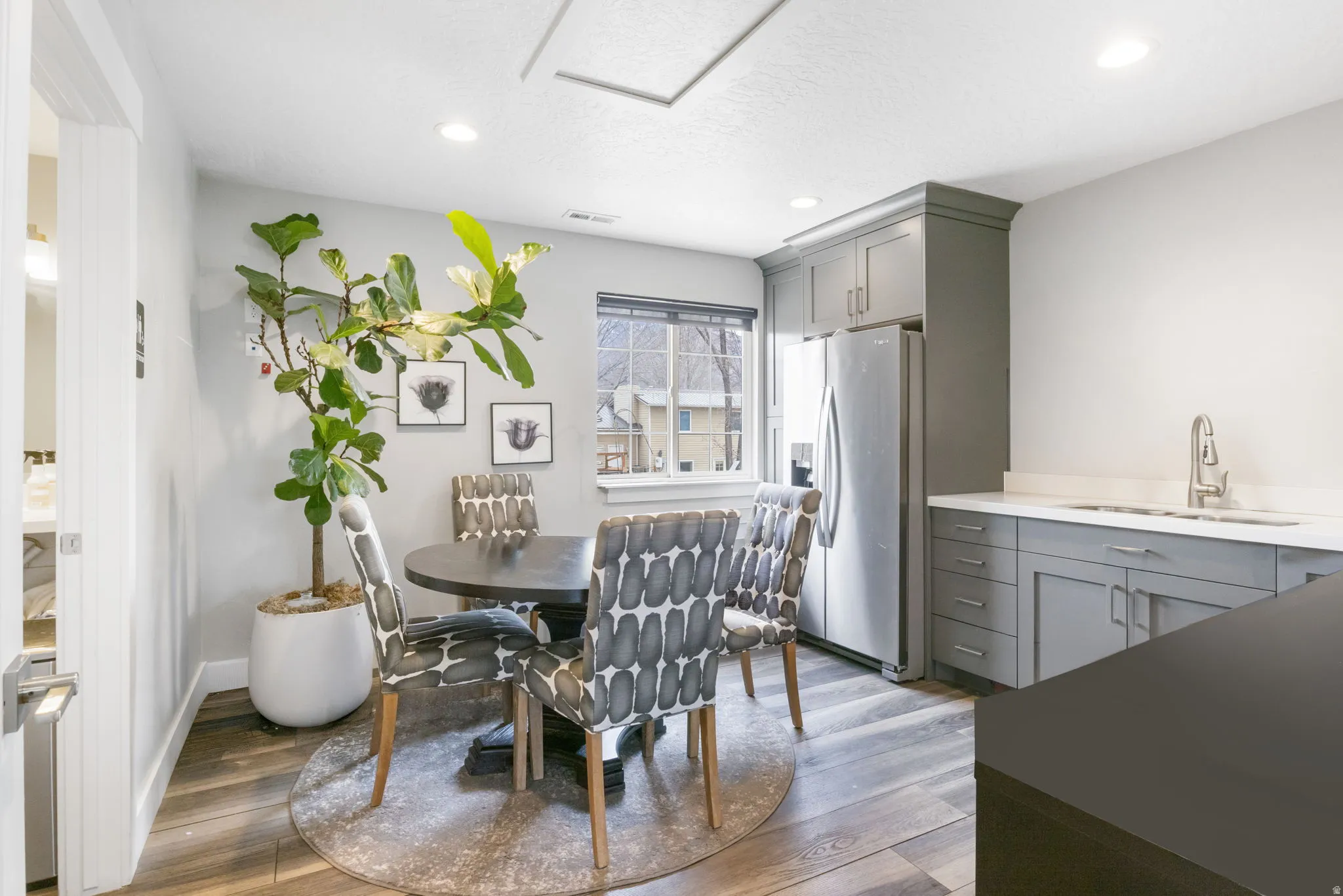 Dining area with dark wood finished floors and recessed lighting