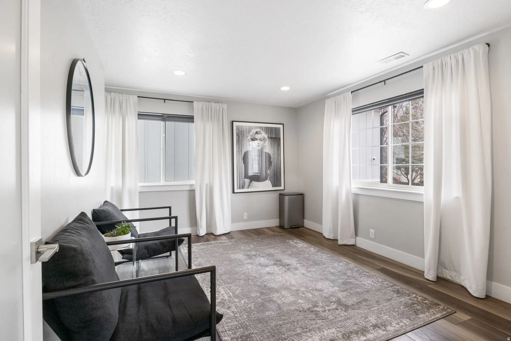 Sitting room with wood finished floors and recessed lighting