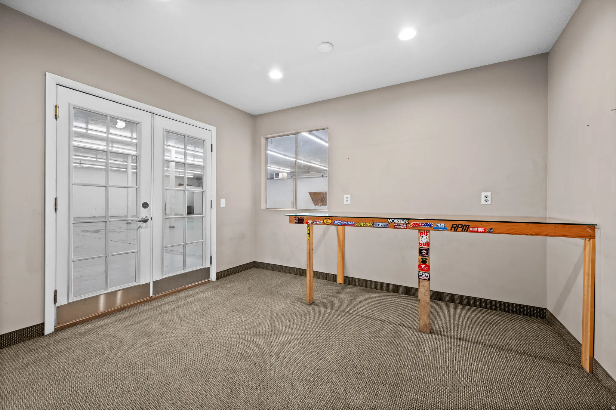 Interior space featuring carpet floors, french doors, and recessed lighting