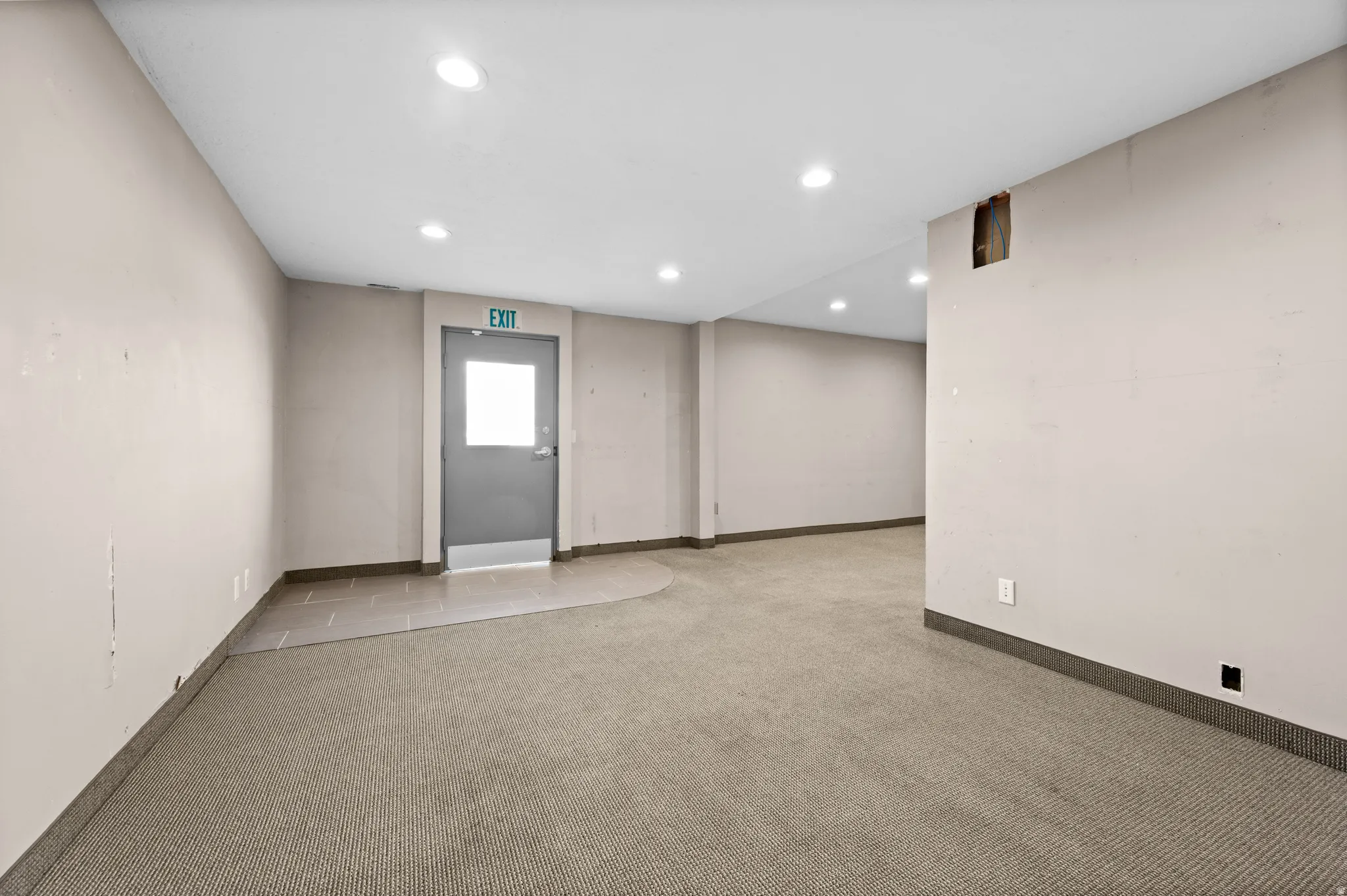Empty room featuring light colored carpet and recessed lighting