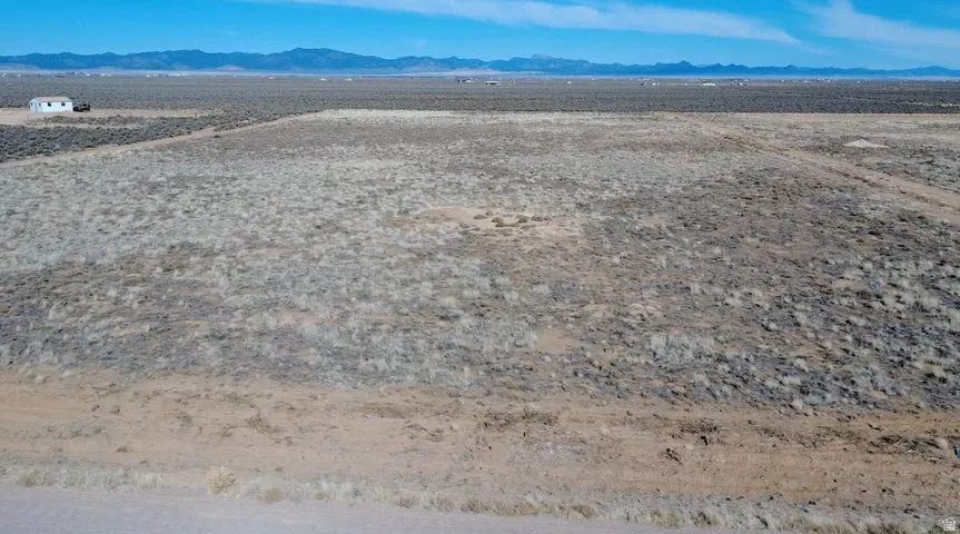 Overview of rural landscape with a mountain backdrop and a desert landscape