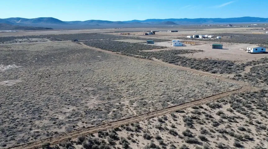 Aerial view of sparsely populated area with a mountain backdrop and a desert landscape