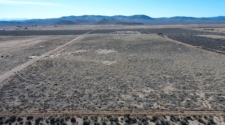 Overview of rural landscape with a mountain backdrop and a desert landscape