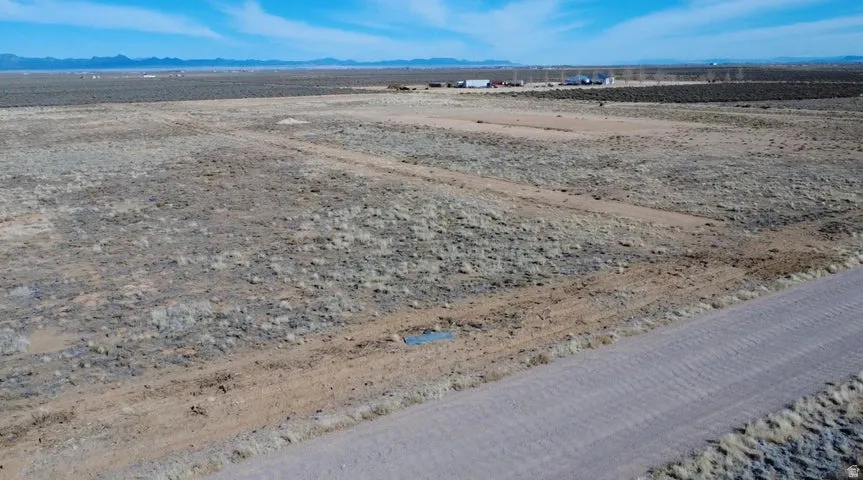 Aerial view of sparsely populated area with a mountain backdrop and a desert landscape
