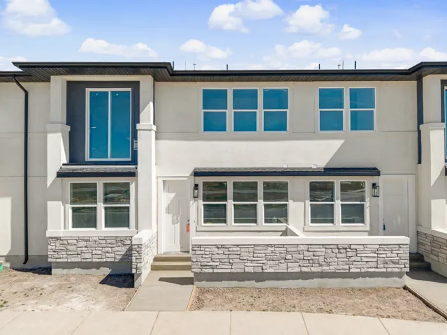 View of front of property with stucco siding and stone siding