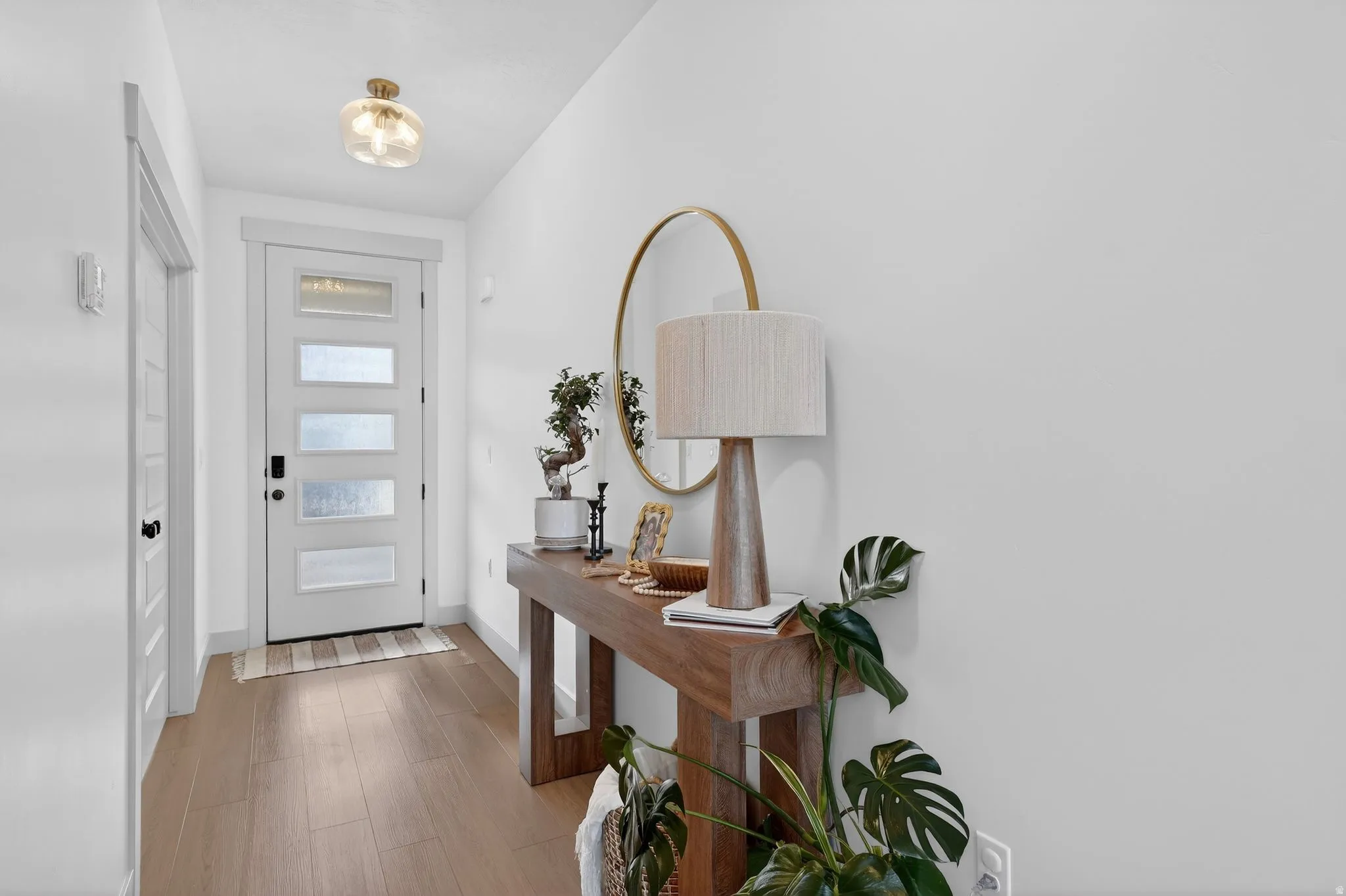 Entryway with light wood-style flooring and baseboards