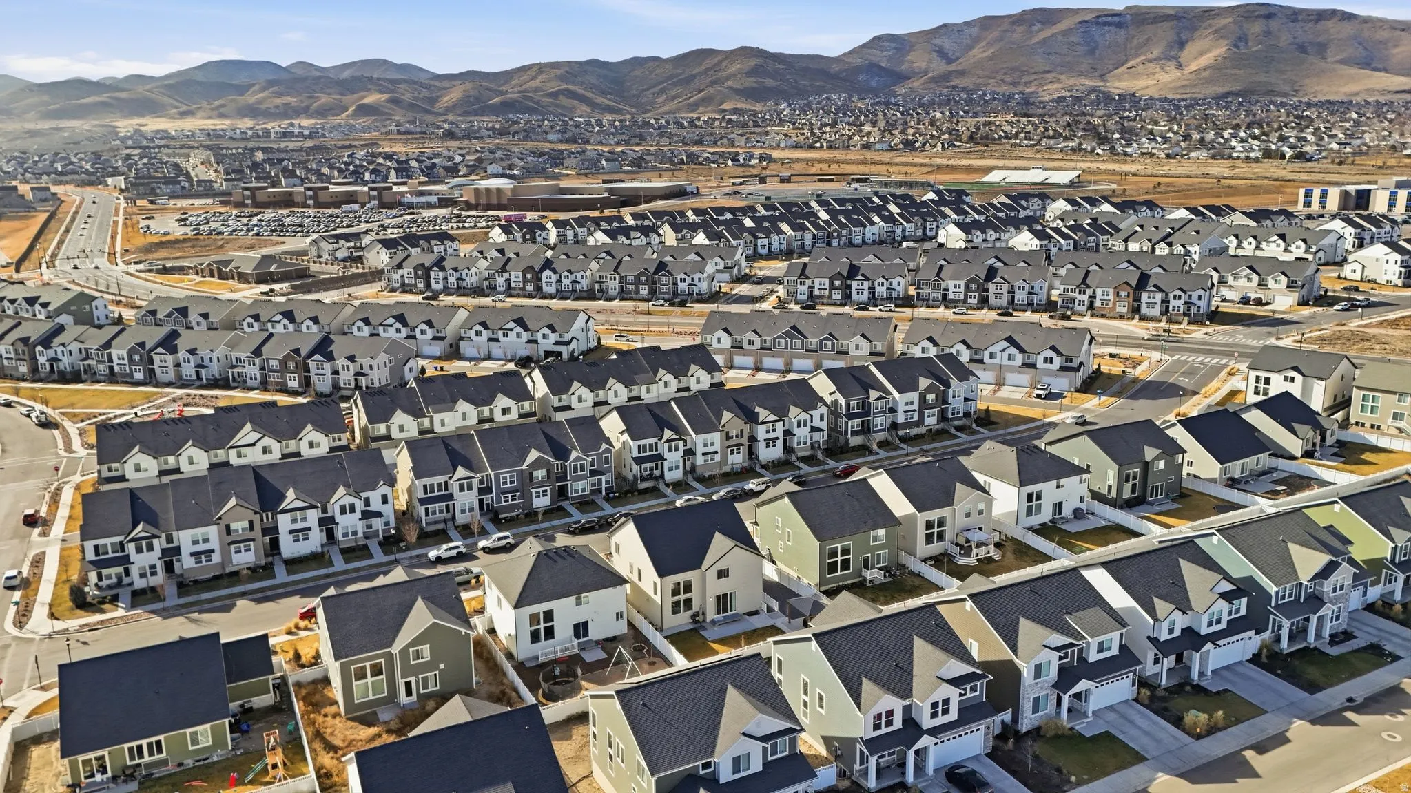 Aerial view of residential area featuring a mountainous background