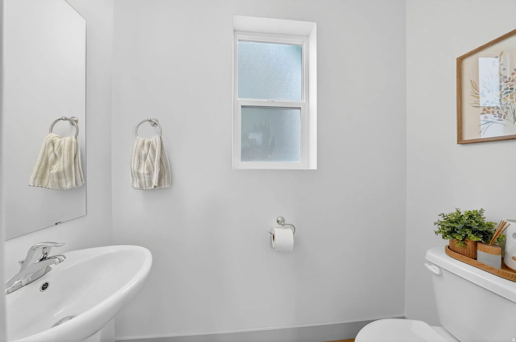 Half bathroom featuring toilet and a sink