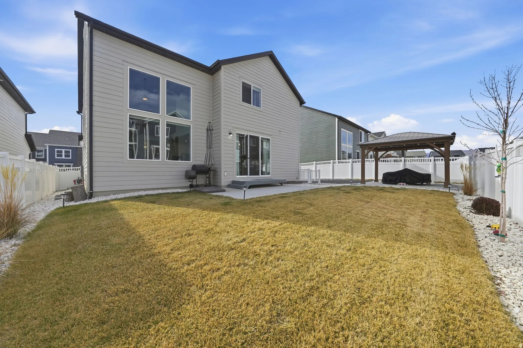 Back of property featuring a patio area, a gazebo, and a fenced backyard
