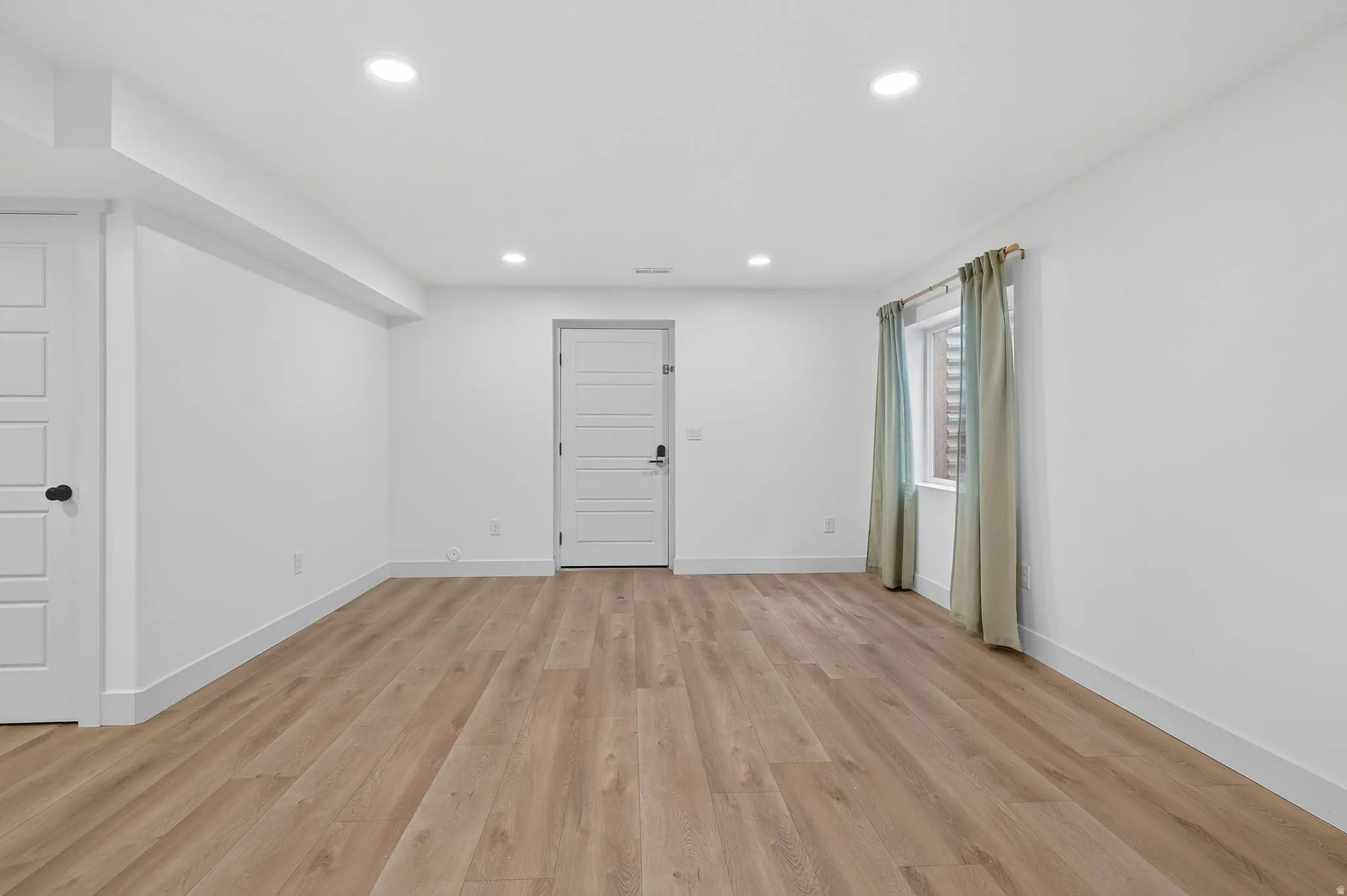 Unfurnished room with light wood-style flooring and recessed lighting
