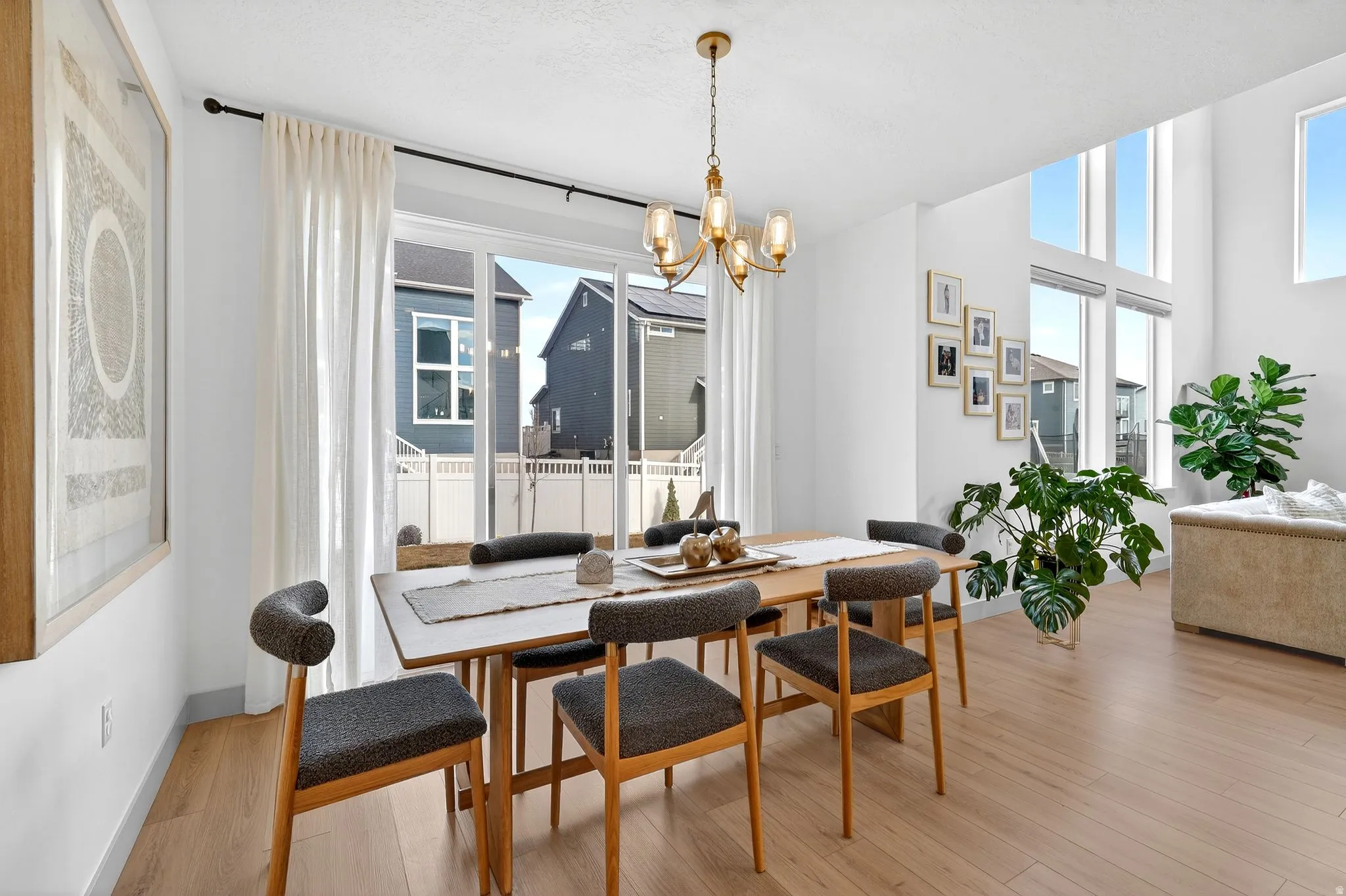 Dining room with light wood-style flooring and hanging lights