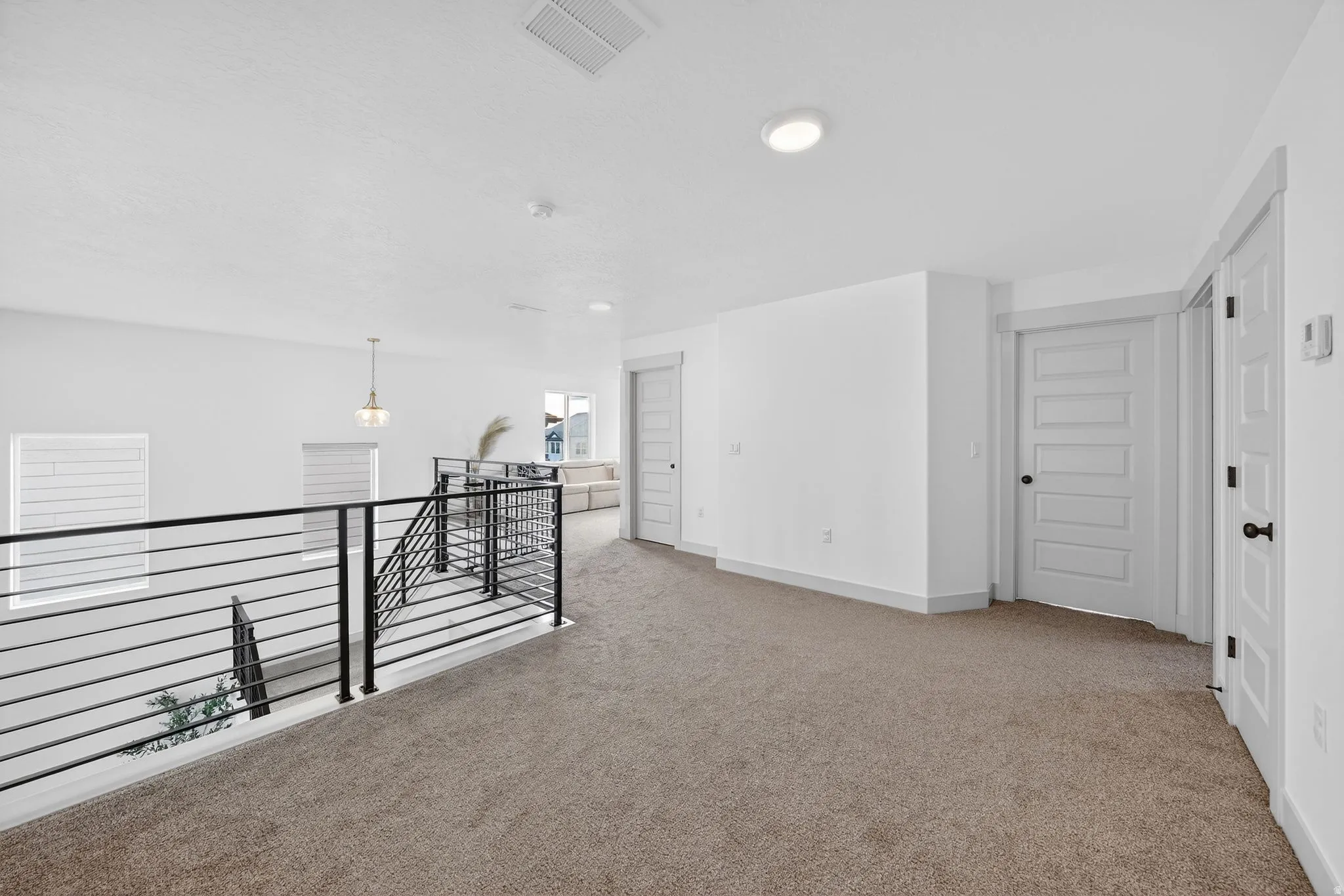Unfurnished room with light carpet and baseboards
