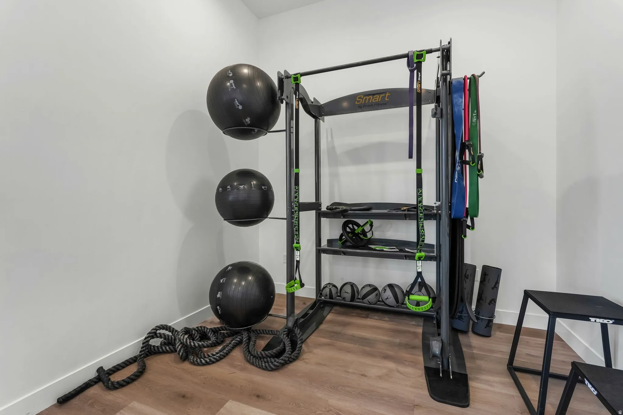 Workout area with wood finished floors and baseboards