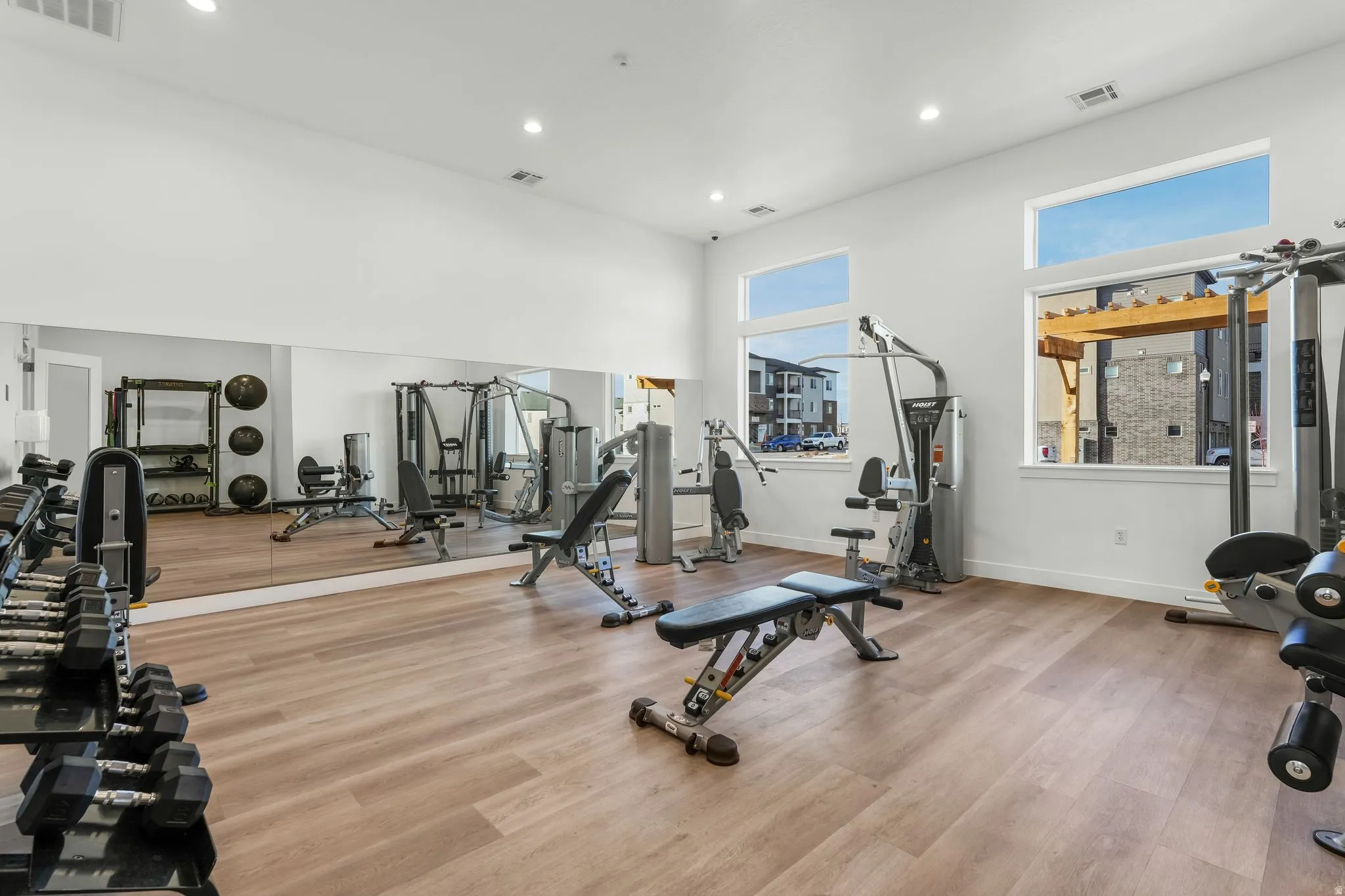Gym with a high ceiling and recessed lighting