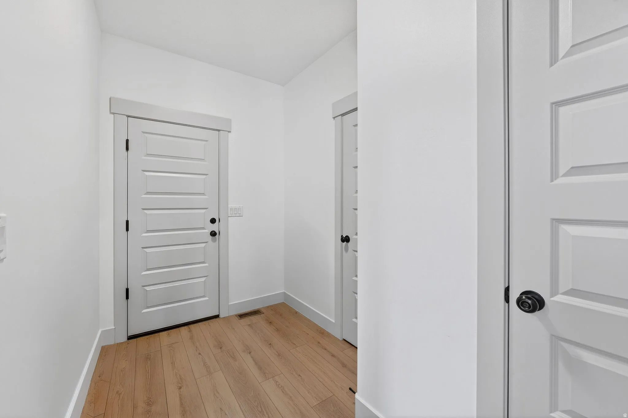 Hall featuring baseboards and light wood-style floors
