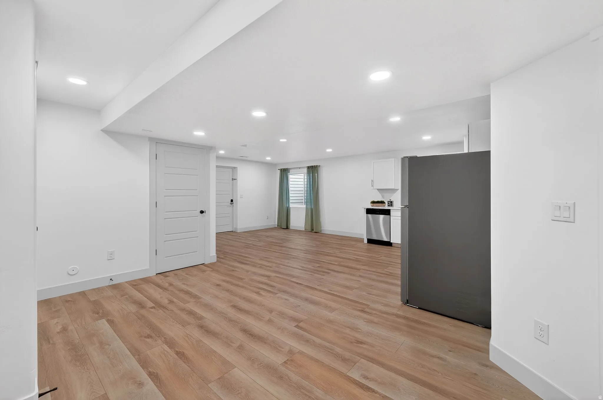 Unfurnished living room with light wood-type flooring and recessed lighting