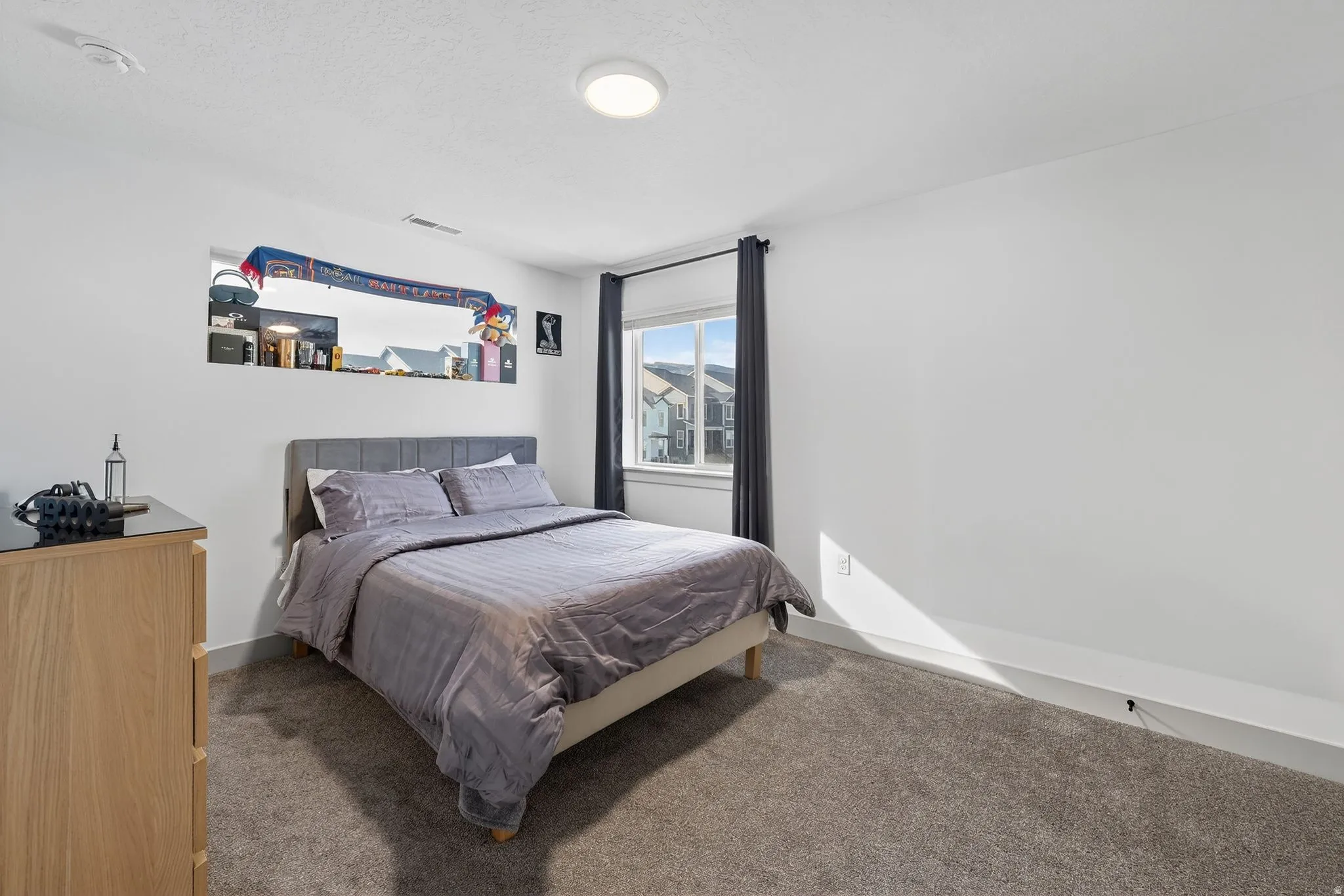 Carpeted bedroom with baseboards