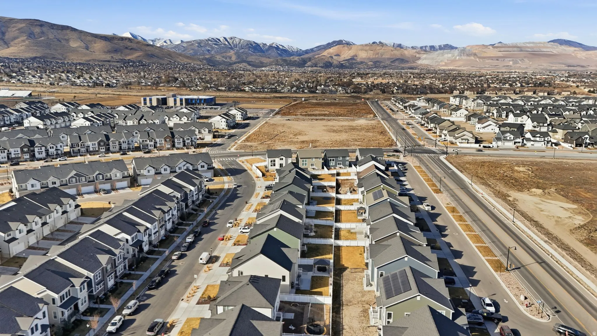 Aerial perspective of suburban area with a mountainous background