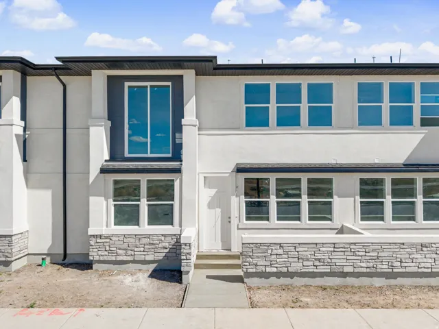 View of front of property with stucco siding and stone siding