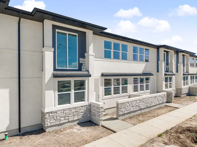 View of front of property featuring stone siding and stucco siding