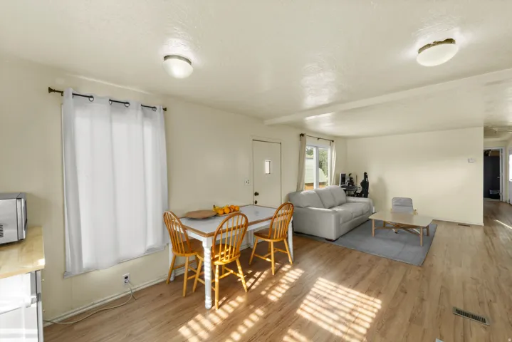 Dining area featuring a textured ceiling and light wood finished floors