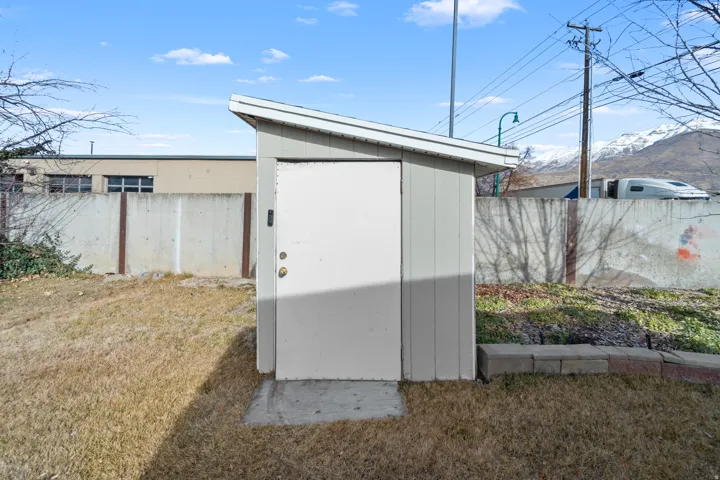 View of shed with a fenced backyard and a mountain view