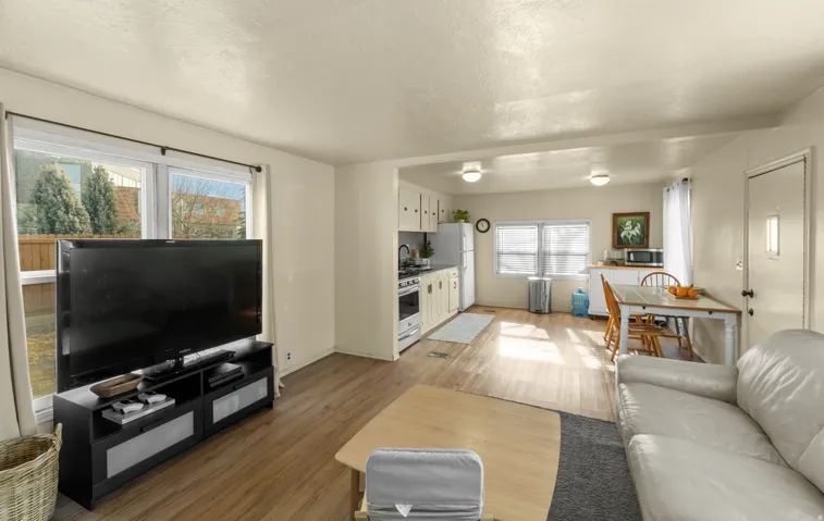 Living area with light wood finished floors and a textured ceiling