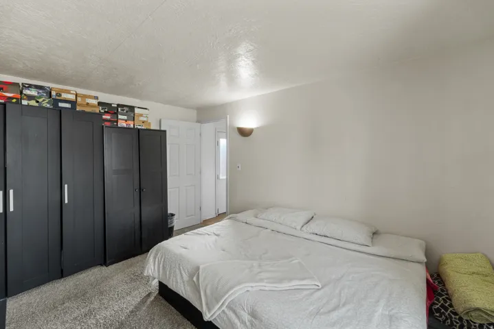Bedroom featuring a textured ceiling and carpet