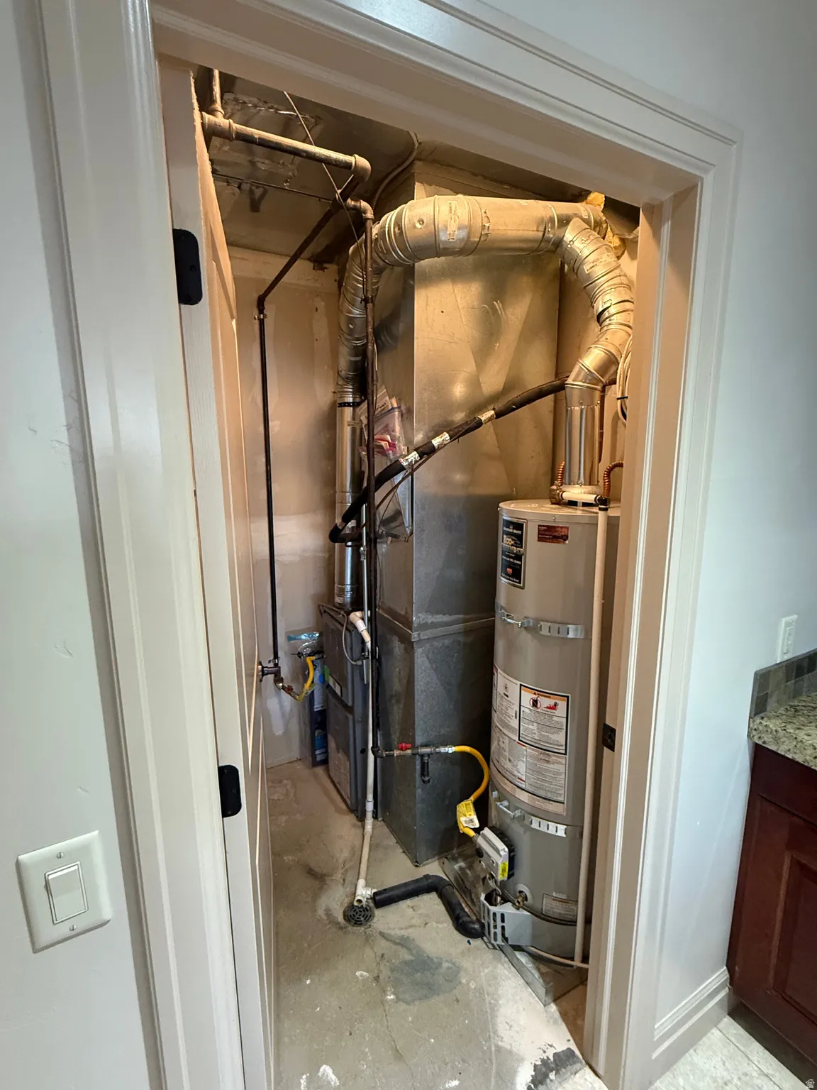Utility room with water heater and heating unit