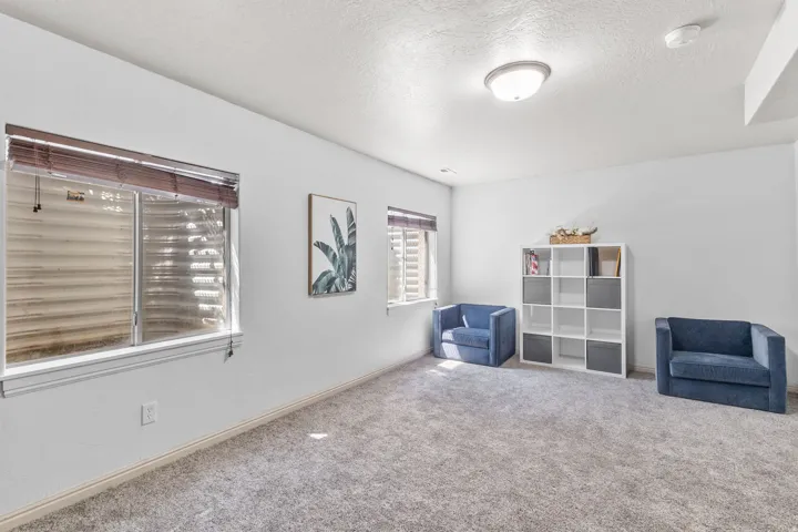 Unfurnished room with carpet and a textured ceiling