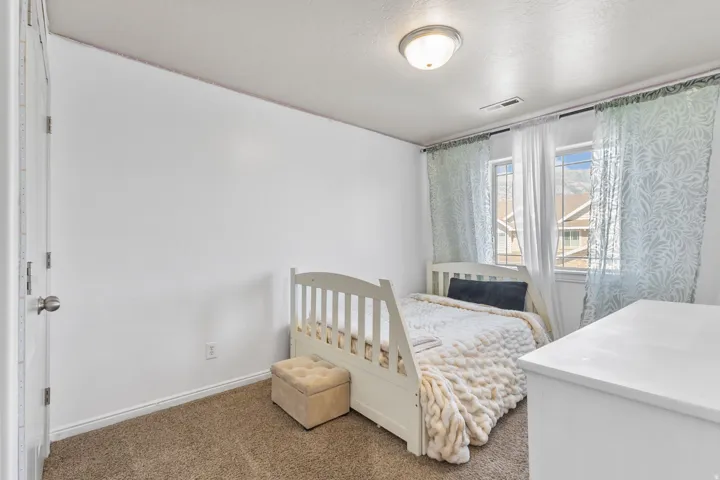 Bedroom with carpet floors and a textured ceiling