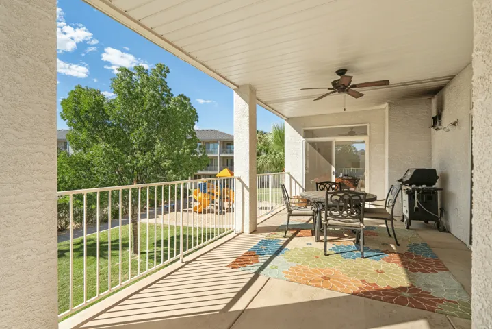 Balcony with outdoor dining area, a ceiling fan, and area for grilling