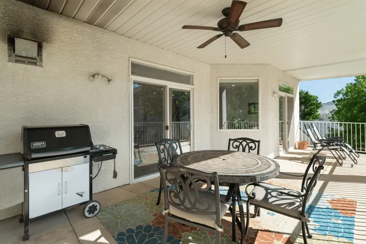 View of patio / terrace with grilling area, outdoor dining area, and ceiling fan