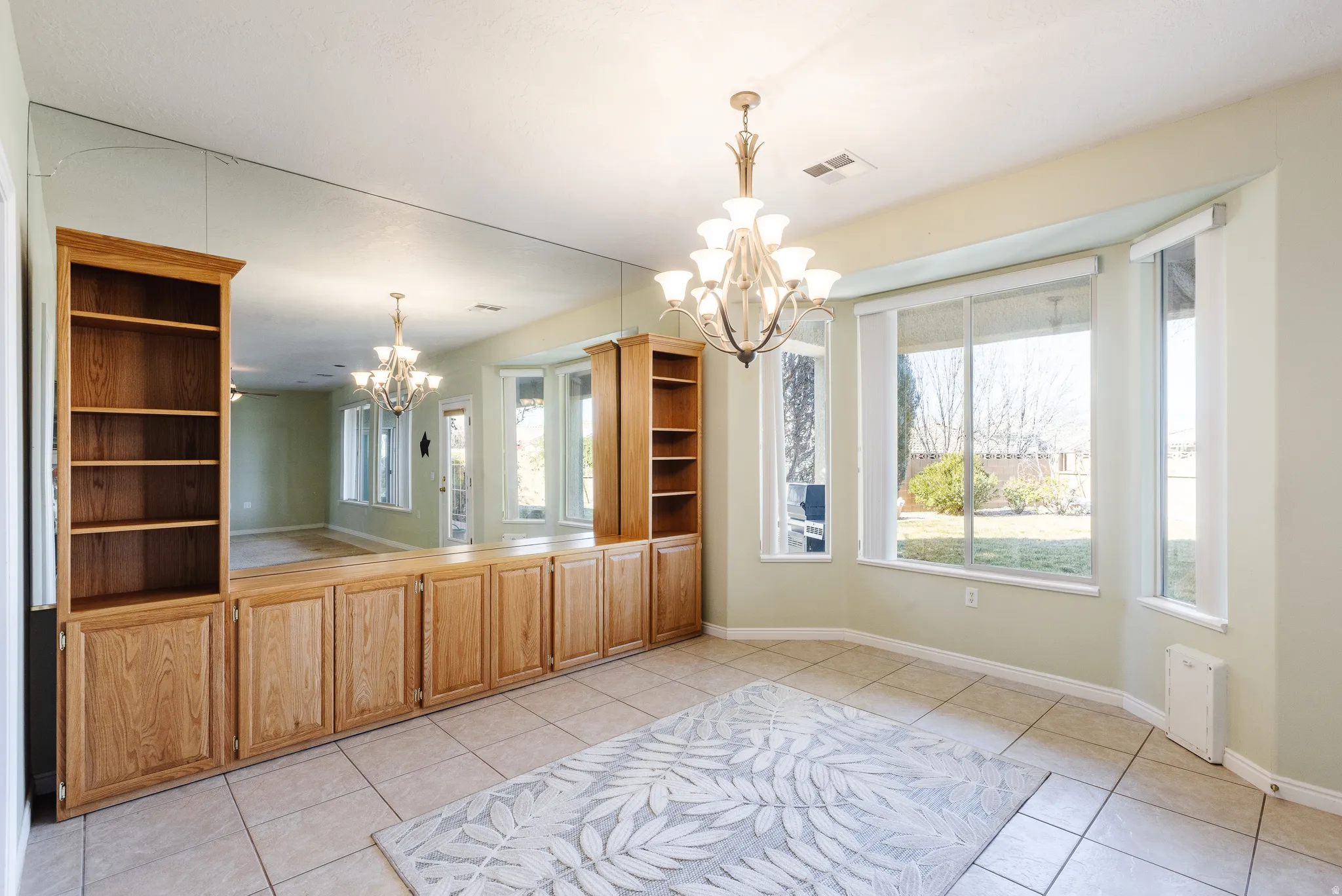 Unfurnished dining area featuring hanging lights and light tile patterned floors