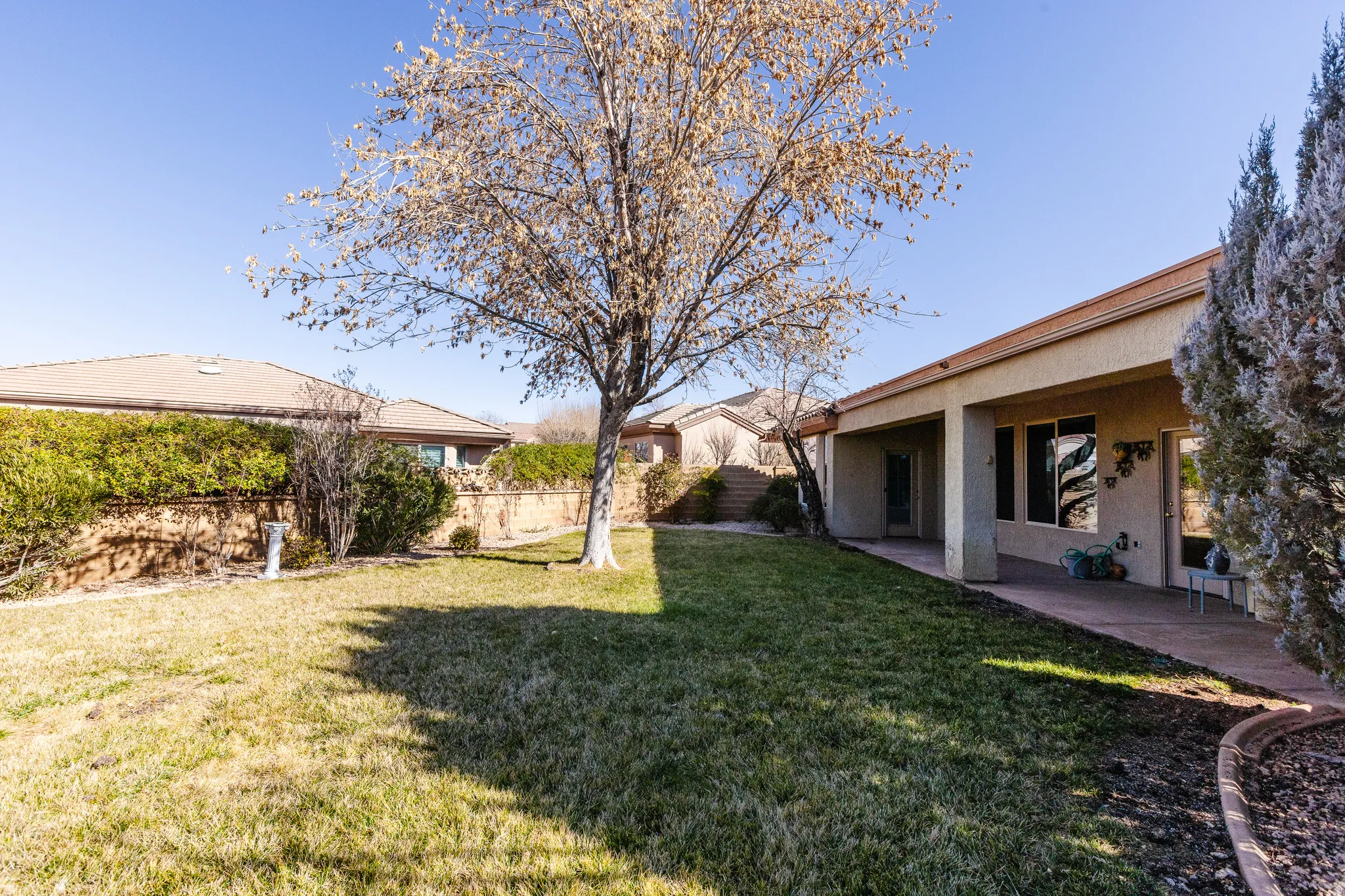 Fenced backyard featuring a patio