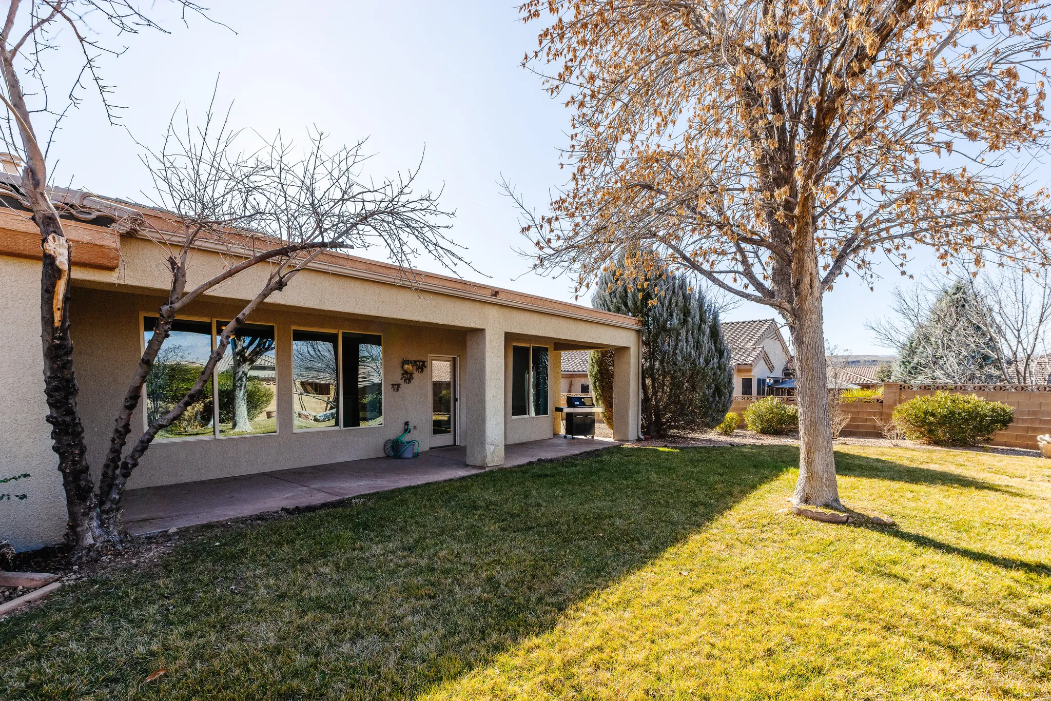 Back of house featuring stucco siding and a patio