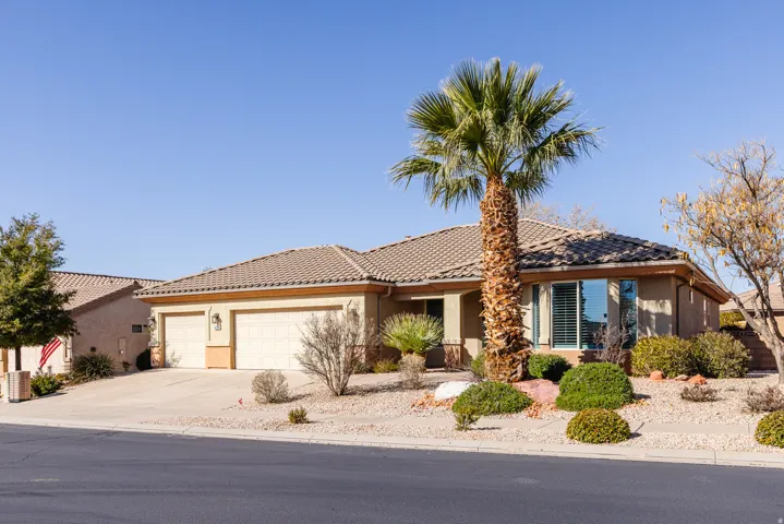 Ranch-style home with stucco siding, a tile roof, concrete driveway, and a garage