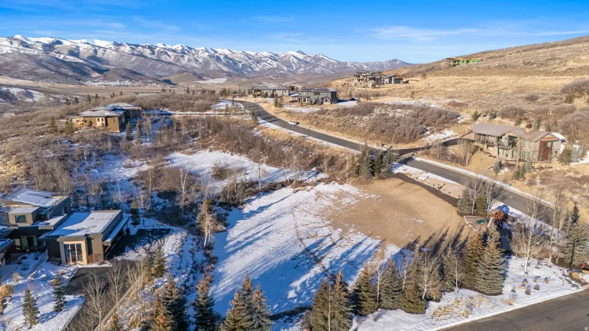 Snowy aerial view with a mountain view and a residential view