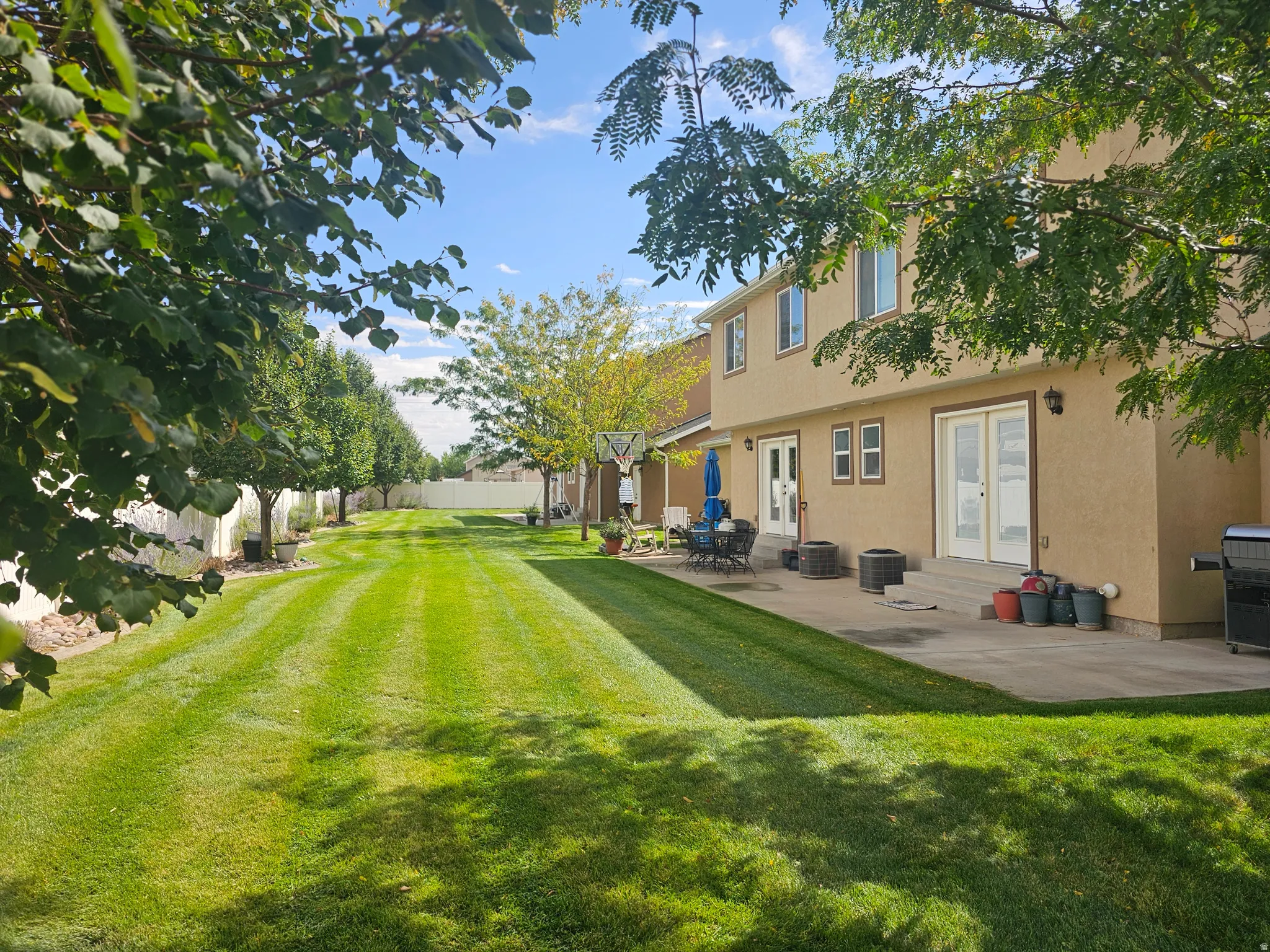 Fenced yard featuring a patio, entry steps, and french doors