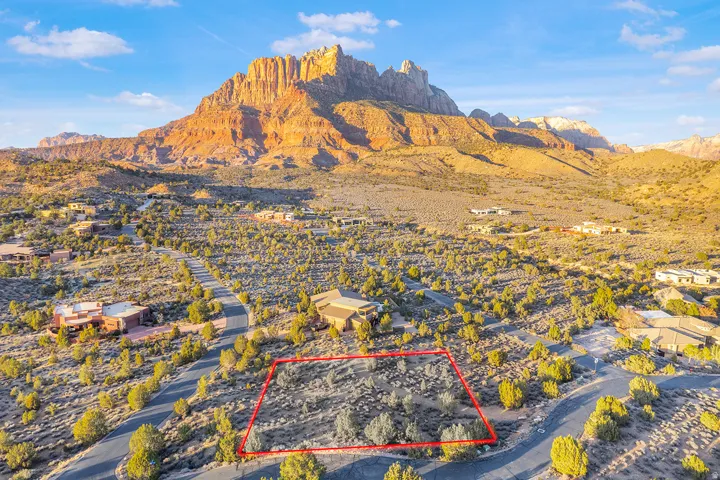 Aerial view of residential area featuring mountains and property parcel outlined